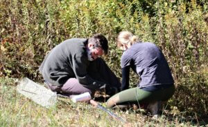 Two volunteers plant trees at Heritage Acres